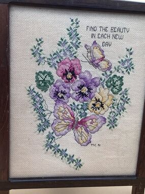 Cross stitch  of pansies and butterflies.